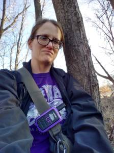 Photo of the author sitting in the woods 